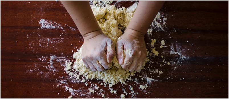 Photo of person kneeding dough