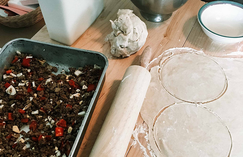 Place a spoonful of filling in each circle of dough. A photo of a the dough circles and the filling