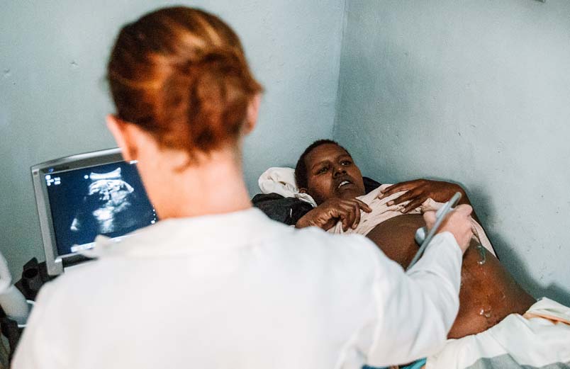 A medical worker does an ultrasound of a patient's abdomen