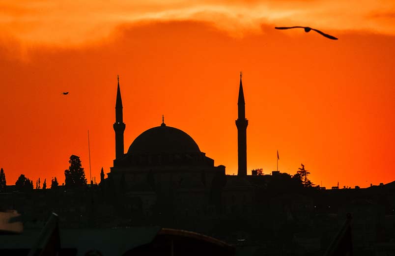 A brilliant sunset behind a mosque