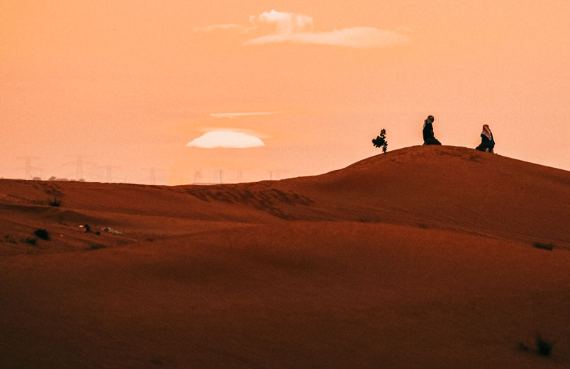 Two people in an arid desert.