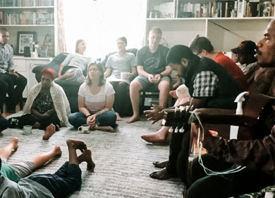 The group remaining at Christian Union Bible College singing worship songs together in a home