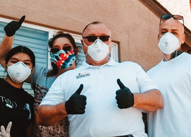 Bob Margaron and four others posing for a picture while wearing masks and gloves