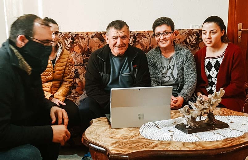 Five people take part in a Zoom call with team members