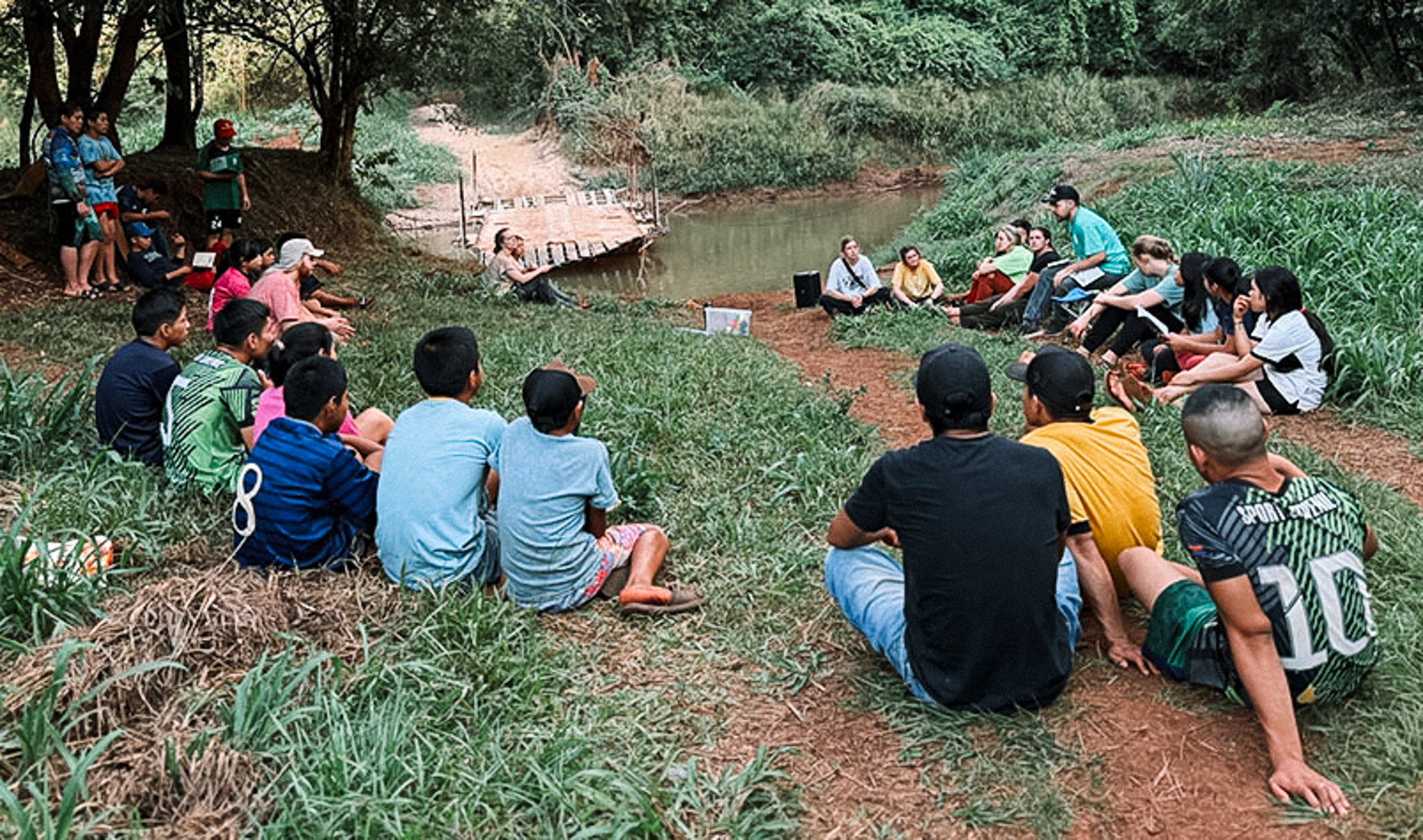 children sitting in a circle listening to a Bible Story