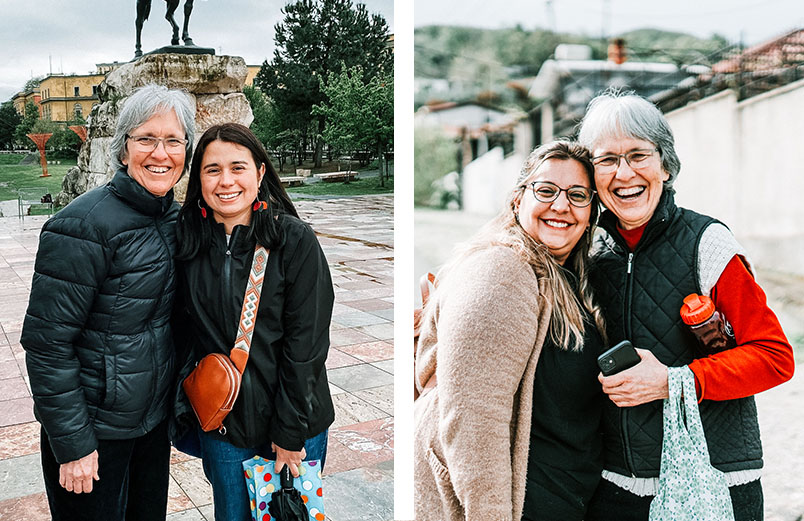 Two women standing in front of landscape